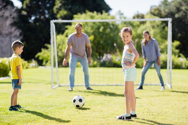 Family playing football together at the park