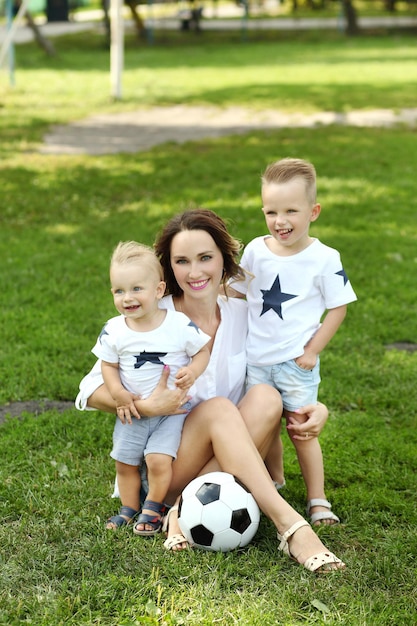 Family playing with the ball in summer park