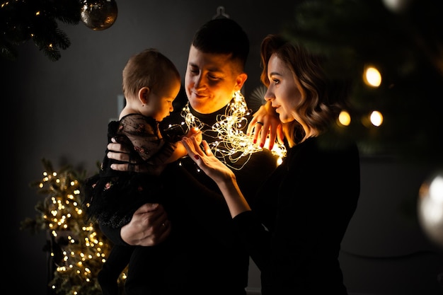 Family portrait. Christmas mood. Dark background