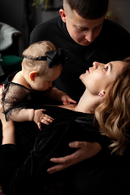 Family portrait. Christmas mood. Dark background