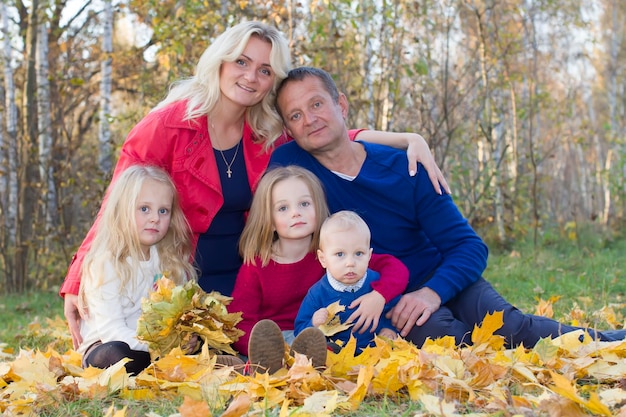 Family portrait in the fall Mom dad daughters and son for a walk