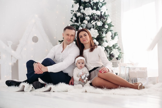 Family posing near the Christmas tree