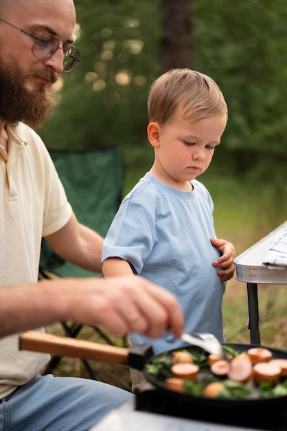 Family preparing dinner while in camping