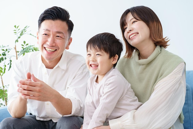 Family relaxing and smiling on the sofa