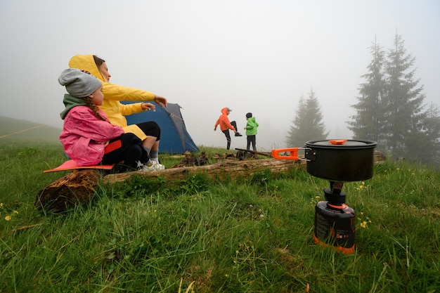 Family rest in the mountains with a tent morning after rain