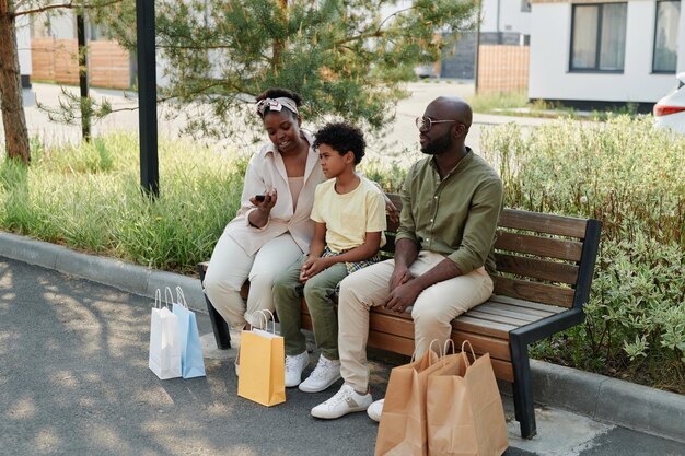 Family resting outdoors after shopping