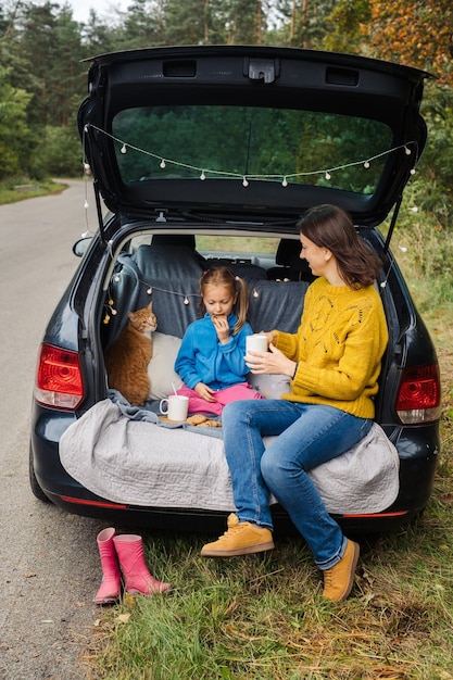 Family road trip with pet sit in car trunk and eat tasty food