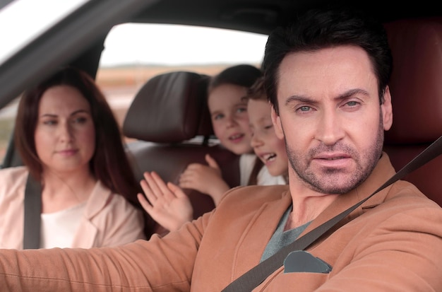 Family sitting in the car looking out windows