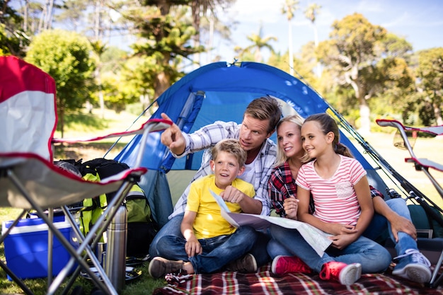 Family sitting in front of tent