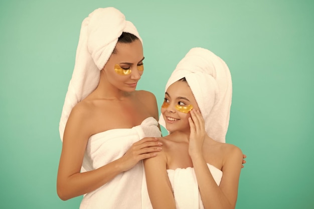 Family spa of mother and daughter with facial patch