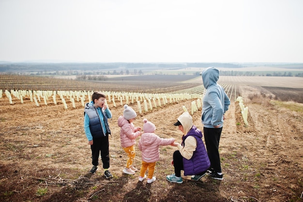 Family stand against vineyard in early spring