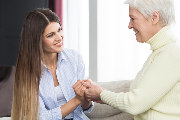 Photo family support daughter holding mother hands and talking