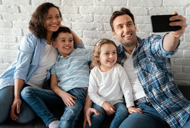 Family taking selfies medium shot