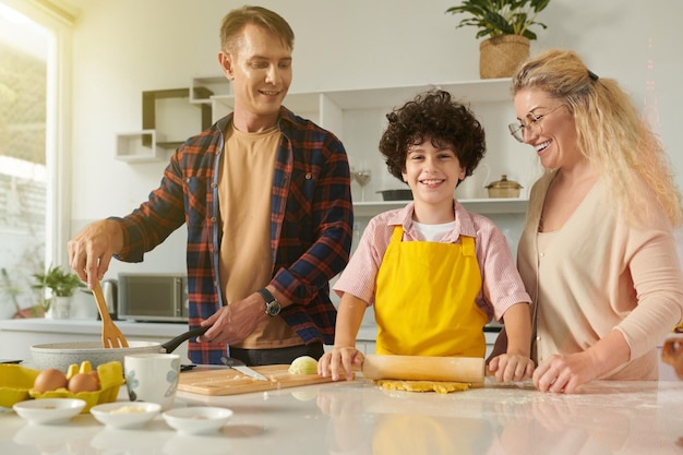 Family of Three Cooking Pasta