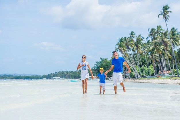 Family of three - father with his child having fun at the beach