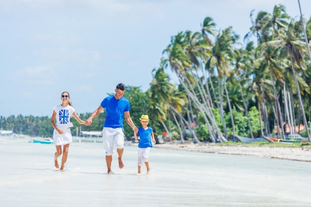 Family of three - father with his child having fun at the beach