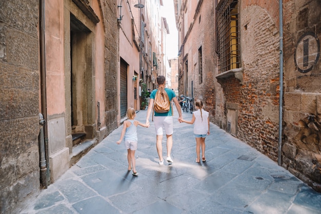 Family of three walking on a empty street