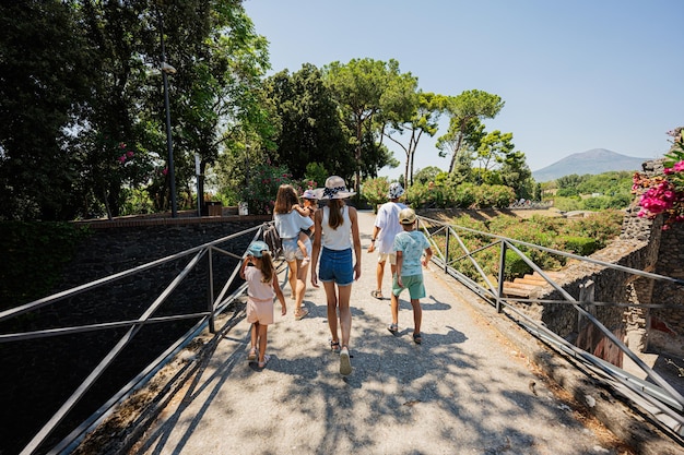 Family tourist walking at garden of Pompeii ancient city Italy