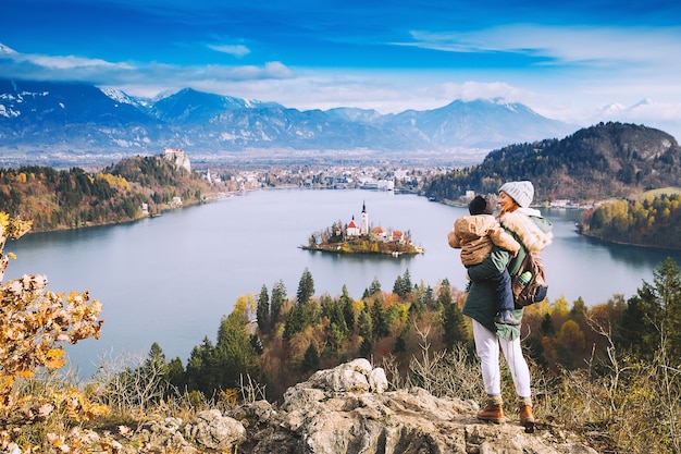 Family travel Europe Mother with son looking on Bled Lake Autumn or Winter in Slovenia Europe