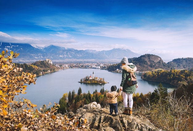 Family travel Europe Mother with son looking on Bled Lake Autumn or Winter in Slovenia Europe