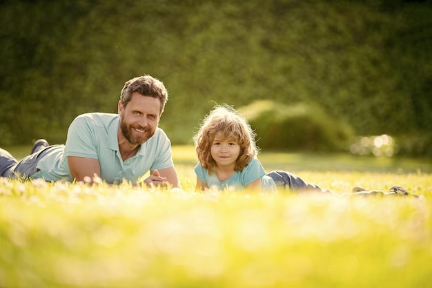 Family value childhood and parenthood parent relax with little child boy on grass