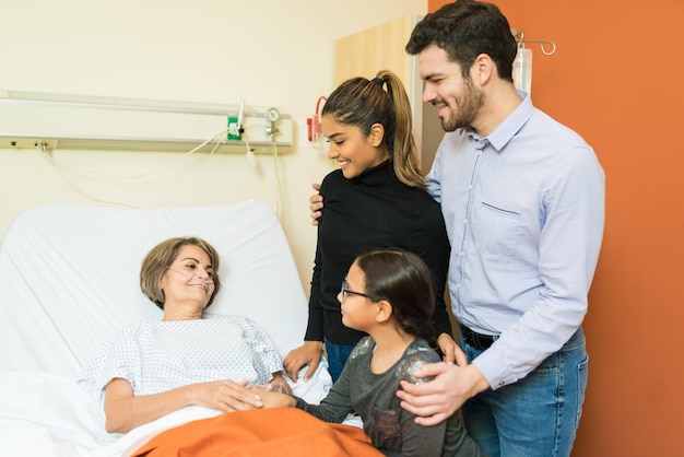 Family visiting senior patient in hospital during treatment