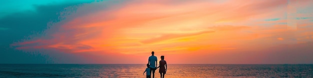 Photo a family walking on the beach at sunset