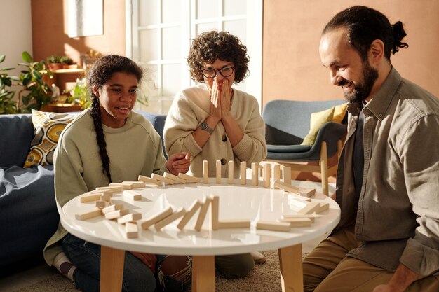 Family with adopted child playing board game