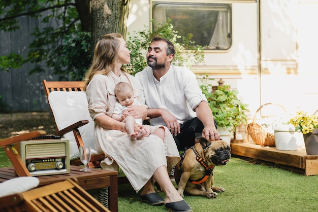 Family with baby and dog near camper van