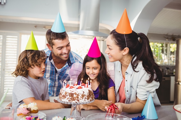 Family with cake at table during birthday celebration