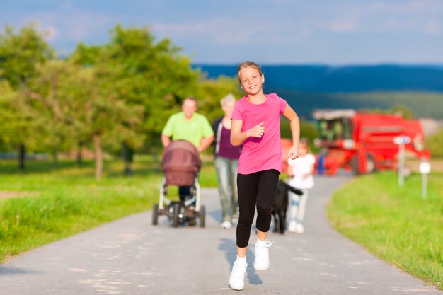 Family with children and dog having walk