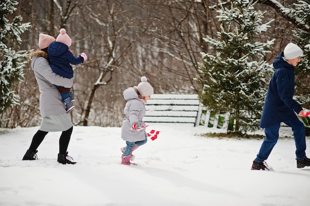 Family with Denmark flags outdoor in winter Travel to Scandinavian countries Happiest danish peoples