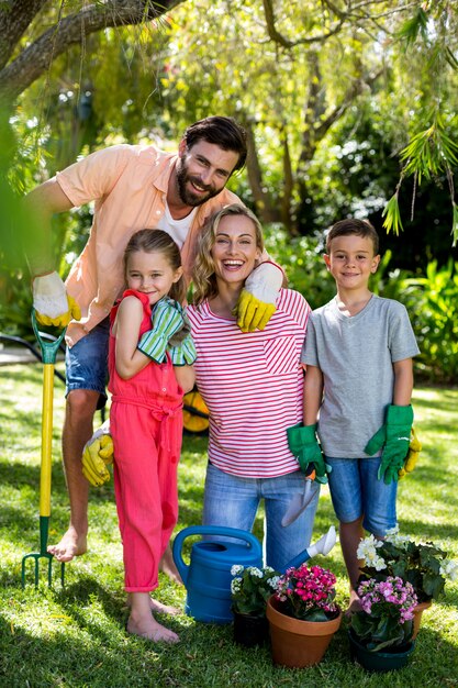 Family with gardening equipment in yard