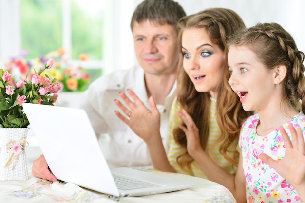 Family with laptop at home