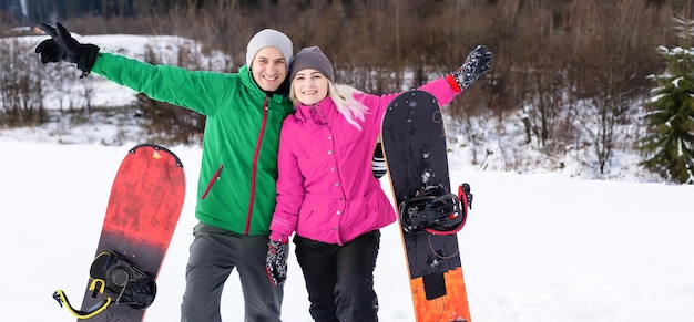 family with snowboards at winter resort