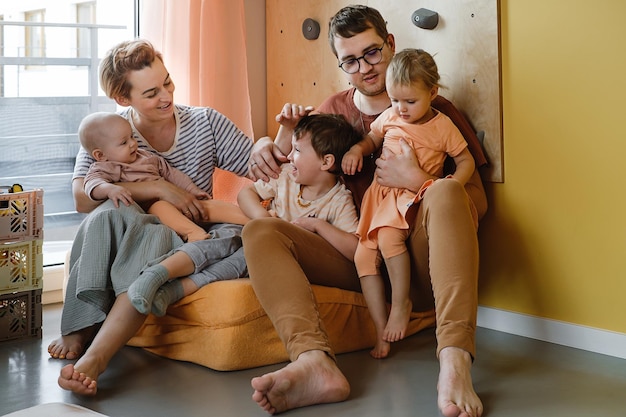 Family with three children playing gamed at home on the floor