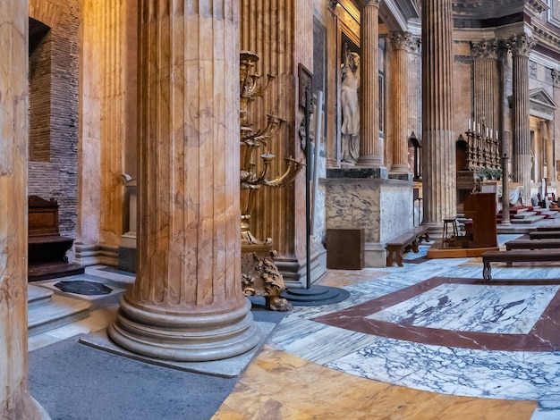 Famous ancient Pantheon interior with colorful marble floor walls columns sculpture Rome Italy