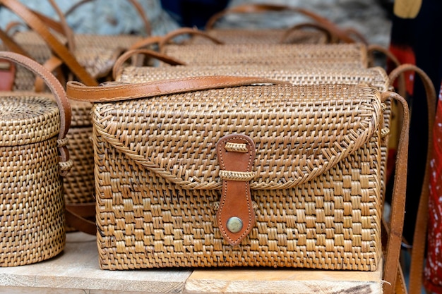 Famous Balinese rattan eco bags in a local souvenir market on street in Ubud Bali Indonesia Handicrafts and souvenir shop display close up