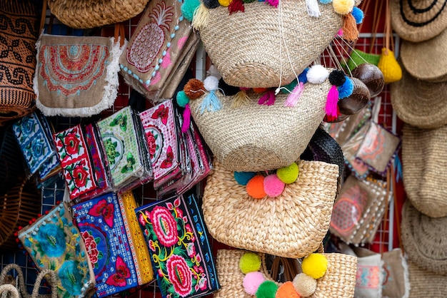 Famous Balinese rattan eco bags in a local souvenir market on street in Ubud Bali Indonesia Handicrafts and souvenir shop display