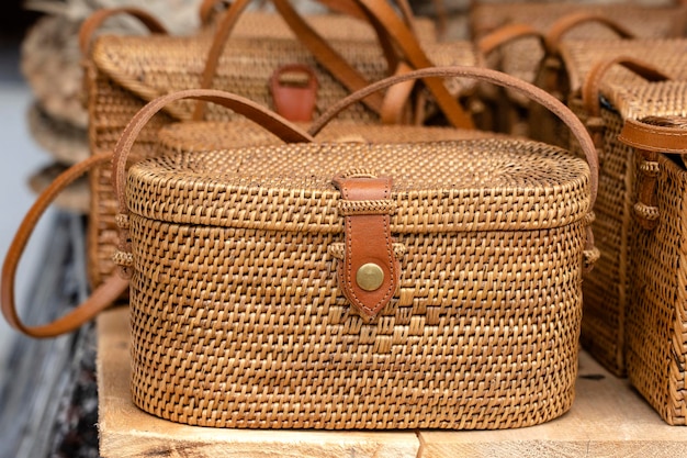 Famous Balinese rattan eco bags in a local souvenir market on street in Ubud Bali Indonesia Handicrafts and souvenir shop display