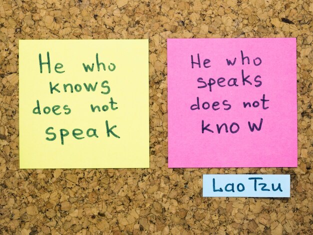 Famous Lao Tzu quote interpretation with sticker notes on cork board