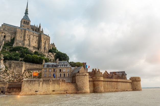 The famous Mont Saint-Michel Abbey at sunrise at high tide in the Manche department, Normandy region, France