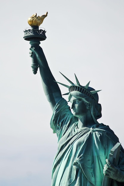 Famous statue of Liberty against the blue sky in New York