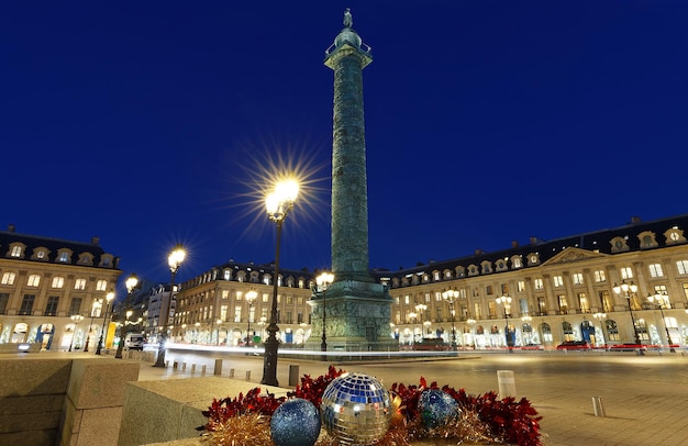 The famous Vendome column at night with Christmas baubles Paris France