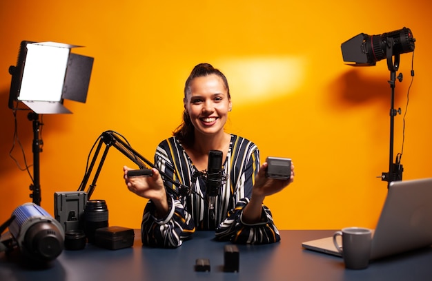 Famous vlogger smiling while recording video about professional accumulators