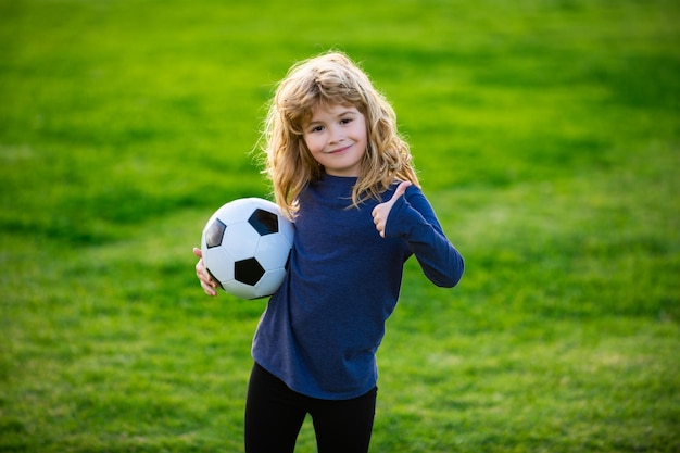 Fan sport boy player hold soccer ball soccer child play football show thumbs up success sign