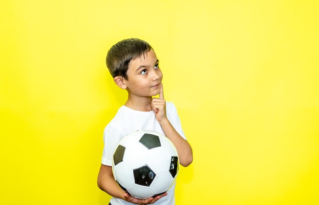 Fan sport boy player hold soccer ball in white tshirt celebrating happy smiling laugh show thumbs