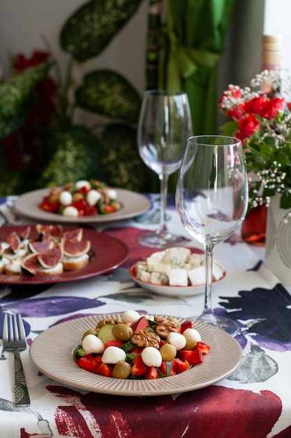 A fancy dinner for two: salad, brie cheese and white bread sandwiches.