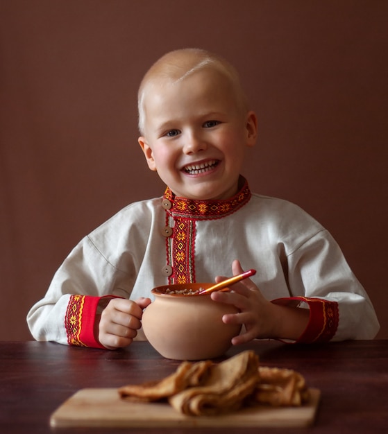 Fanny Face boy  With Bagels. Outdoor In Winter Time. Shrovetide (Maslenitsa) Concept.