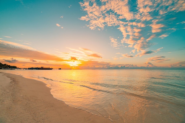 Fantastic closeup beach calm sea water waves orange sunrise sunset sunlight. Tropical island shore